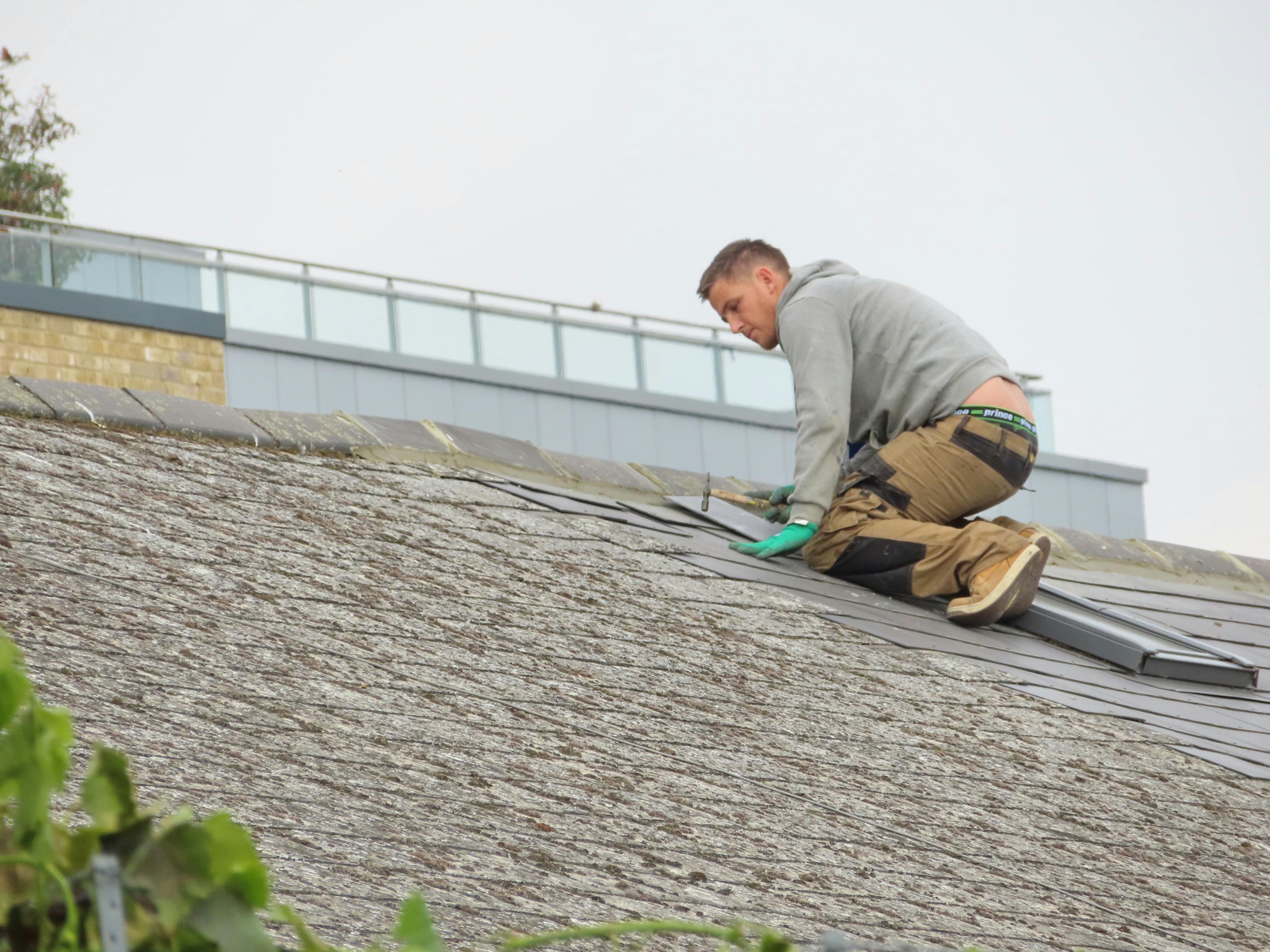 Pulse Roofing technician performing roof repair inspection in Atlanta