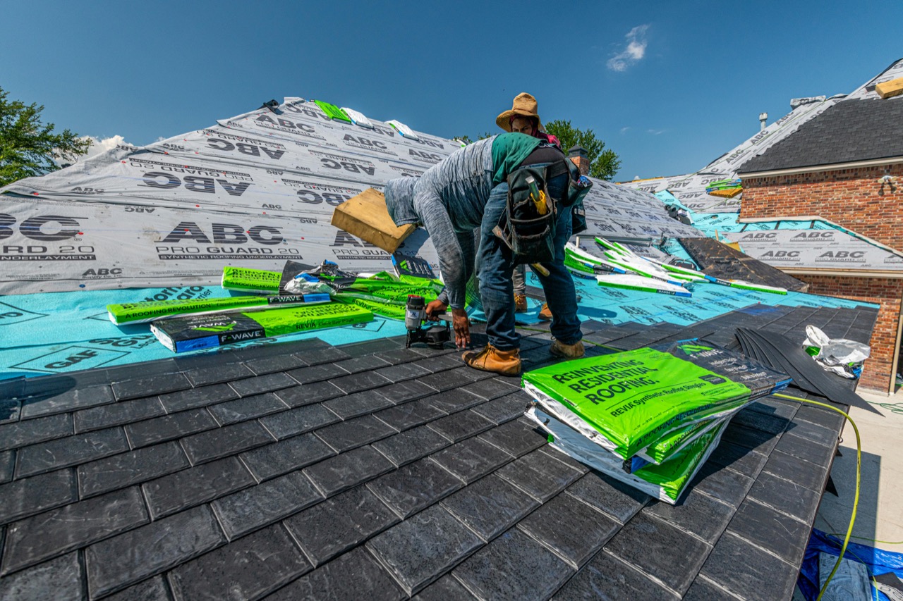 Pulse Roofing crew laying shingles on residential roof